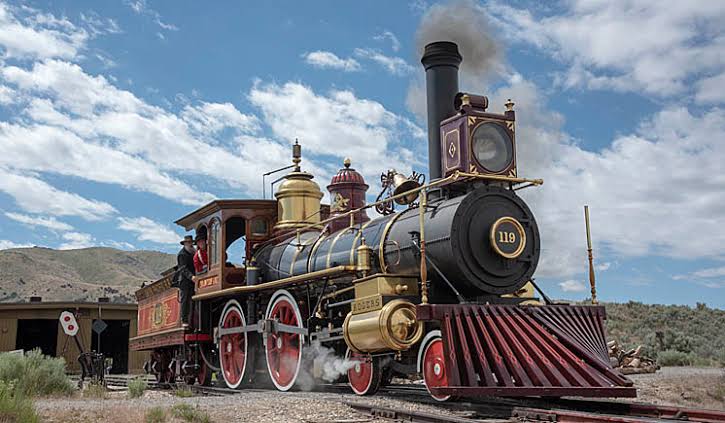 Transcontinental train crossing open desert landscape